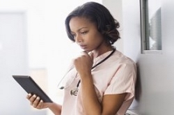 A nurse holding a tablet.