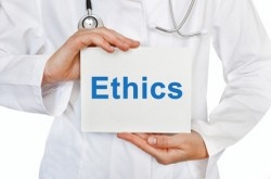 Picture of a doctor holding a sign that says ethics.