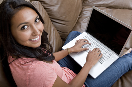 Women on couch using laptop