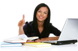 Nurse giving a thumbs up while studying.