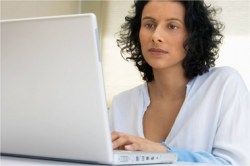 Lady on laptop purchasing her course. 